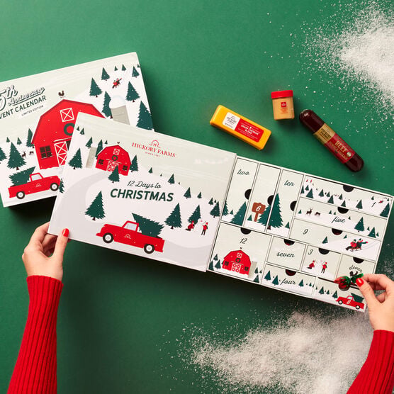 12 Days of Charcuterie Advent Calendar being opened on green background